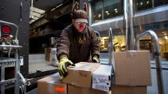 A UPS delivery man prepares to deliver packages on Christmas Eve in New York